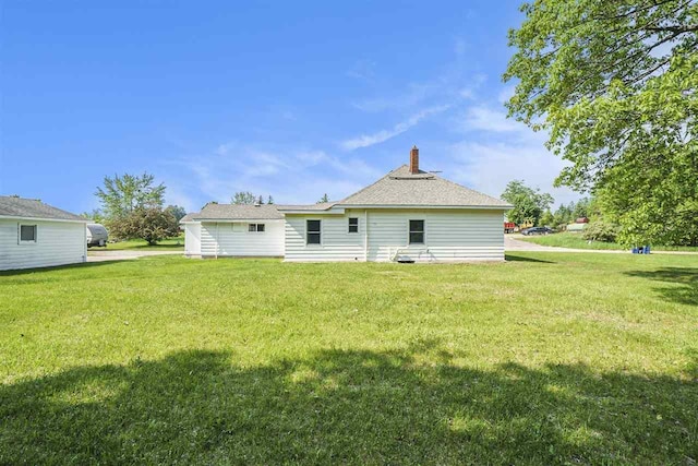 5791 Lebaron St, Levering, MI 49755 - rear view of property featuring a lawn and a chimney