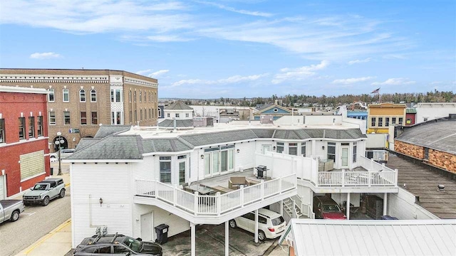 193 E Main St Unit 4, Harbor Springs, MI 49740 - rear view of house featuring roof with shingles