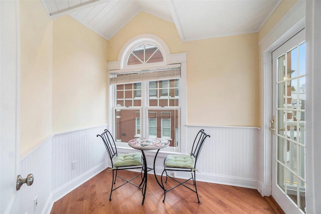 195 E Main St Unit 5, Harbor Springs, MI 49740 - dining area featuring wainscoting, wood finished floors, and vaulted ceiling