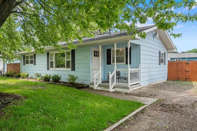 1105 Grant St, Charlevoix, MI 49720 - ranch-style home with a porch and driveway