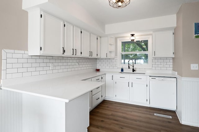 1105 Grant St, Charlevoix, MI 49720 - kitchen featuring dishwasher, a sink, white cabinetry, and wainscoting