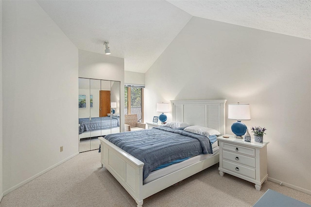 3480 Lakeside Dr N Unit 35, Petoskey, MI 49770 - bedroom with vaulted ceiling, light colored carpet, baseboards, and a textured ceiling