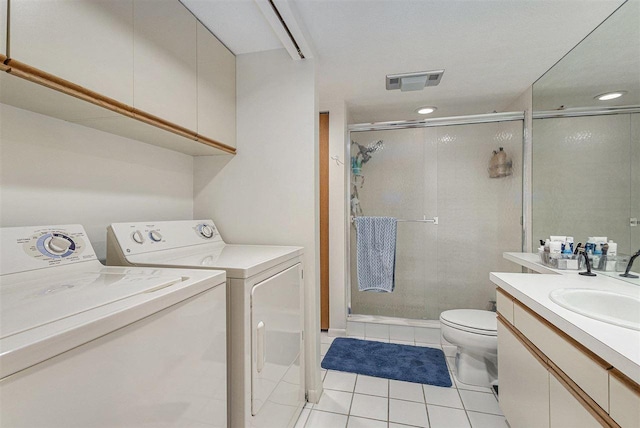 3480 Lakeside Dr N Unit 35, Petoskey, MI 49770 - bathroom featuring washer and dryer, tile patterned flooring, vanity, toilet, and a shower stall