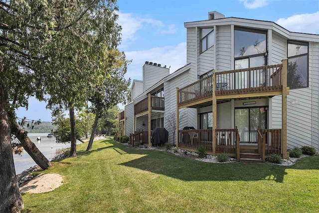 3480 Lakeside Dr N Unit 35, Petoskey, MI 49770 - back of house featuring a lawn and a chimney