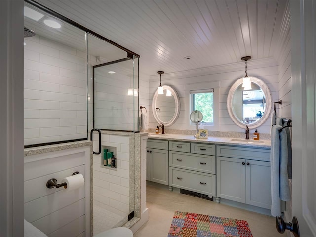 169 E Shadow Trails Rd, Boyne City, MI 49712 - bathroom featuring a stall shower, double vanity, and crown molding