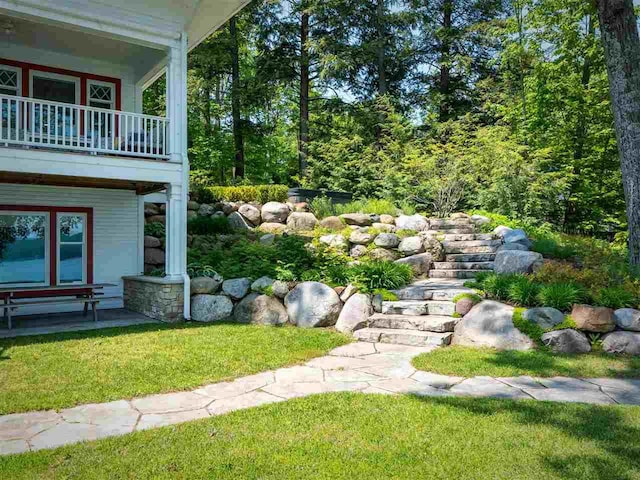 169 E Shadow Trails Rd, Boyne City, MI 49712 - view of green lawn with a balcony