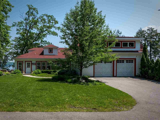 169 E Shadow Trails Rd, Boyne City, MI 49712 - view of front of property featuring an attached garage, driveway, and a front lawn