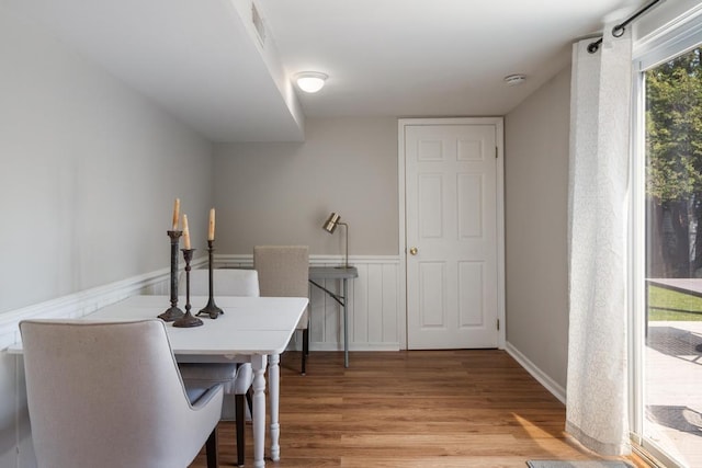 1029 Howard St, Petoskey, MI 49770 - dining space featuring light wood-style floors and wainscoting