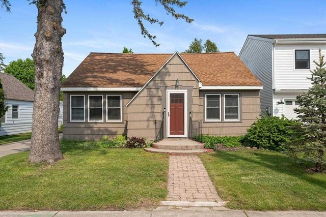 1029 Howard St, Petoskey, MI 49770 - view of front of home with a front yard and roof with shingles