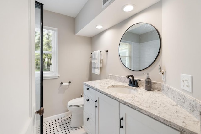 1029 Howard St, Petoskey, MI 49770 - full bath with vanity, toilet, baseboards, and tile patterned flooring