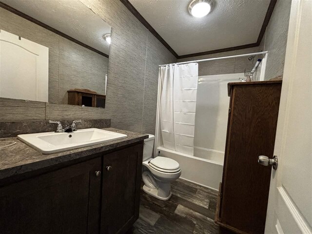 6685 M-66 N, Charlevoix, MI 49720 - full bathroom with wood finished floors, crown molding, vanity, toilet, and shower / bath combo with shower curtain