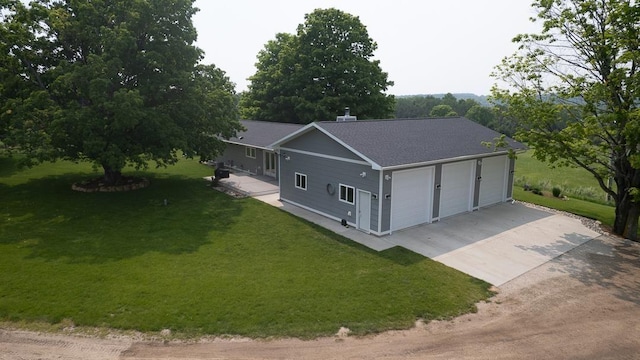 8512 Dutchman Bay Rd, East Jordan, MI 49727 - view of front facade featuring a shingled roof, a garage, a front yard, and dirt driveway