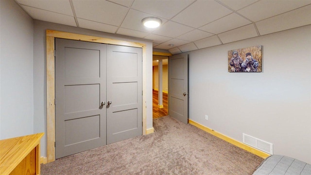 8512 Dutchman Bay Rd, East Jordan, MI 49727 - unfurnished bedroom with carpet, a paneled ceiling, and a closet
