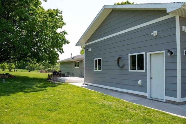 8512 Dutchman Bay Rd, East Jordan, MI 49727 - back of property featuring a lawn and a patio