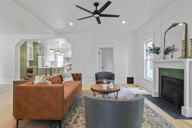 503 N Bridge St, Bellaire, MI 49615 - living area featuring a fireplace, ceiling fan, light wood-style floors, recessed lighting, and baseboards