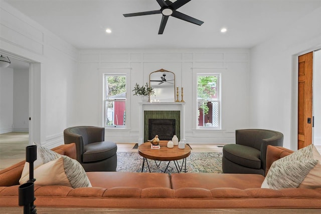 503 N Bridge St, Bellaire, MI 49615 - living room featuring a ceiling fan, wood finished floors, a fireplace, recessed lighting, and healthy amount of natural light