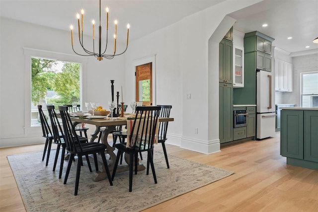 503 N Bridge St, Bellaire, MI 49615 - dining area featuring light wood-style floors, a chandelier, recessed lighting, and baseboards