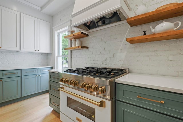 503 N Bridge St, Bellaire, MI 49615 - kitchen featuring open shelves, gas stove, green cabinets, custom exhaust hood, and white cabinets