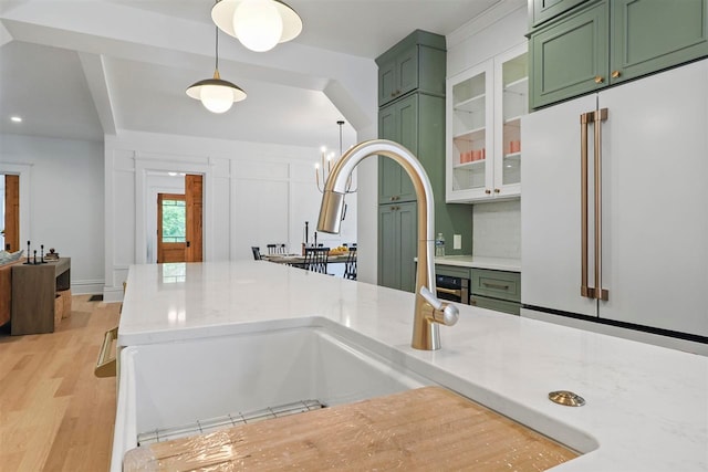 503 N Bridge St, Bellaire, MI 49615 - kitchen with green cabinets, high end fridge, light wood-style flooring, and a sink
