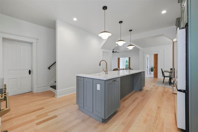 503 N Bridge St, Bellaire, MI 49615 - kitchen with a sink, light wood-type flooring, light countertops, an island with sink, and recessed lighting
