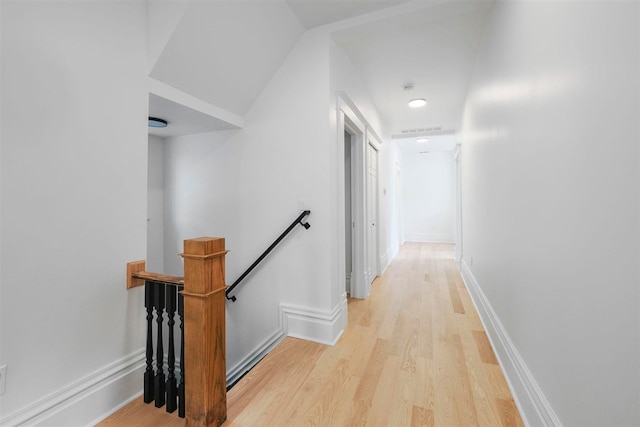 503 N Bridge St, Bellaire, MI 49615 - hallway featuring an upstairs landing, light wood-style floors, and baseboards