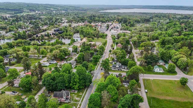 503 N Bridge St, Bellaire, MI 49615 - aerial view of property and surrounding area with a large body of water and a heavily wooded area
