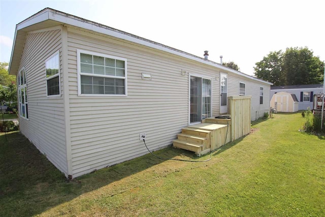 6685 M-66 Hwy, Charlevoix, MI 49720 - rear view of property featuring a storage shed and a yard