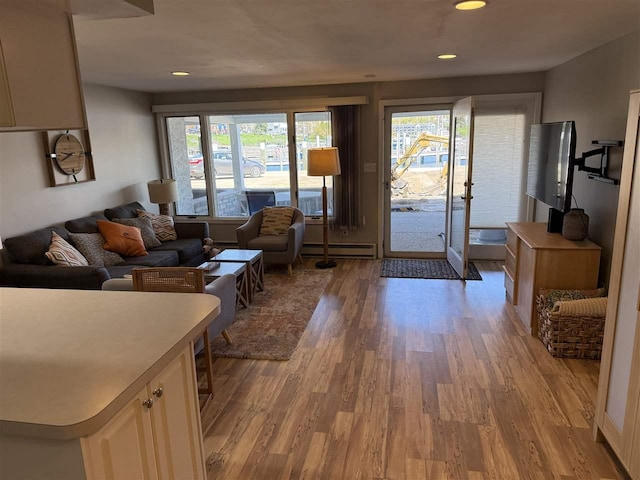 107 Belvedere Ave Unit A-3, Charlevoix, MI 49720 - living area with a baseboard radiator, light wood-style floors, and recessed lighting