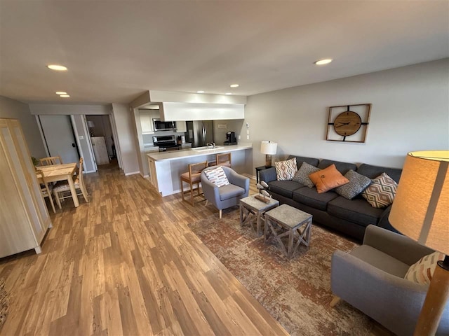 107 Belvedere Ave Unit A-3, Charlevoix, MI 49720 - living room with light wood-style floors and recessed lighting