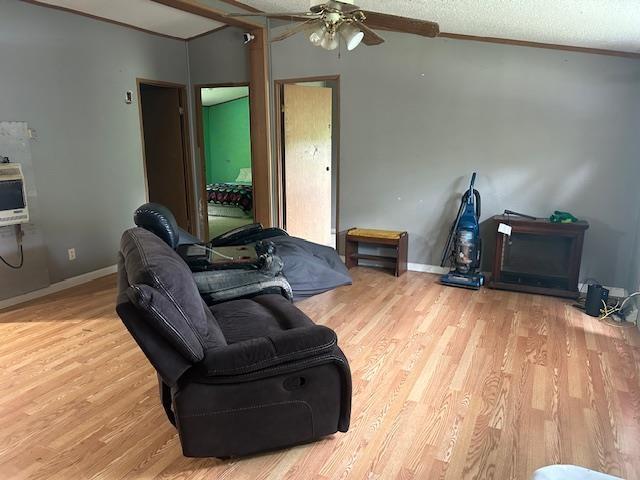 9540 Pickerel Lake Rd, Petoskey, MI 49770 - living room with a ceiling fan, wood finished floors, and ornamental molding