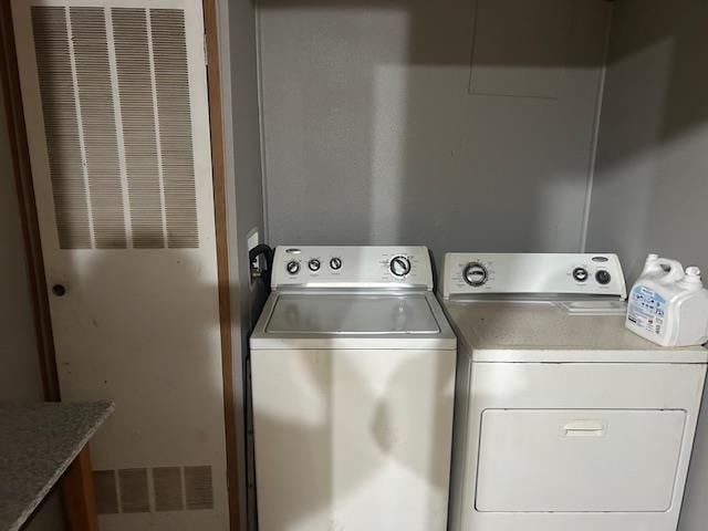 9540 Pickerel Lake Rd, Petoskey, MI 49770 - washroom featuring separate washer and dryer and a heating unit