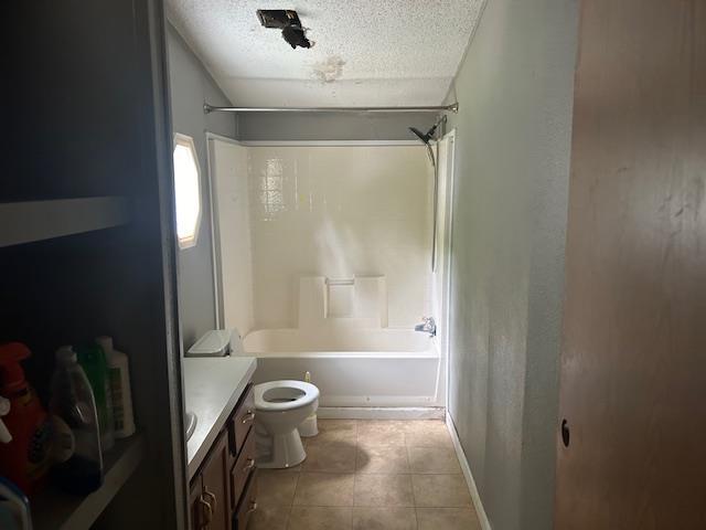 9540 Pickerel Lake Rd, Petoskey, MI 49770 - bathroom with a textured ceiling, bathtub / shower combination, vanity, and tile patterned floors