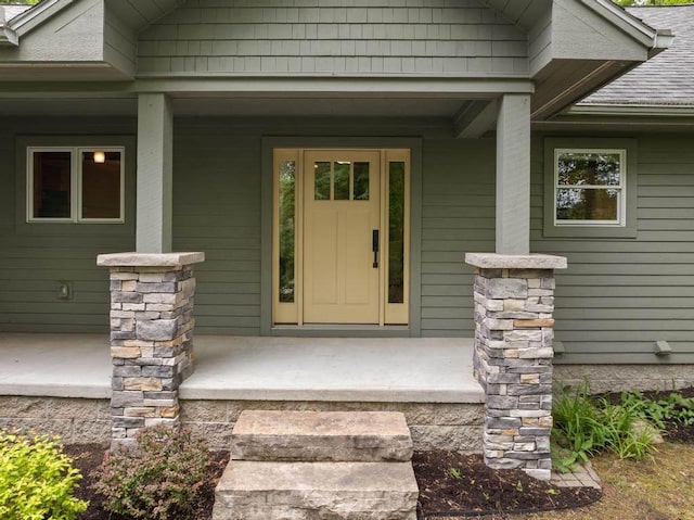 1752 Turnberry Trl, Boyne City, MI 49712 - entrance to property with a porch and roof with shingles