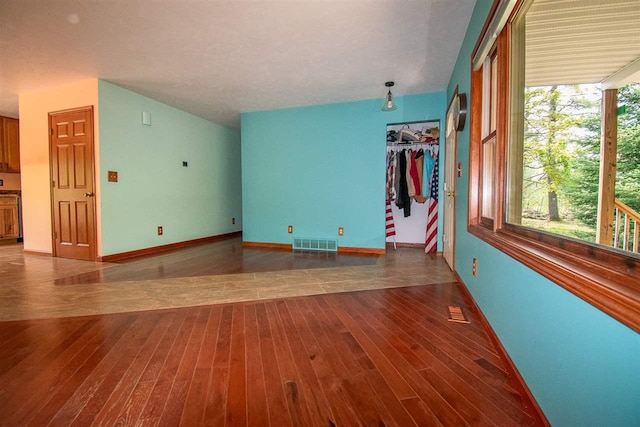 2335 Lone Pine Rd, Gaylord, MI 49735 - unfurnished living room with wood finished floors and baseboards