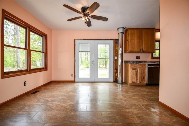 2335 Lone Pine Rd, Gaylord, MI 49735 - kitchen with dishwasher, brown cabinets, ceiling fan, and french doors