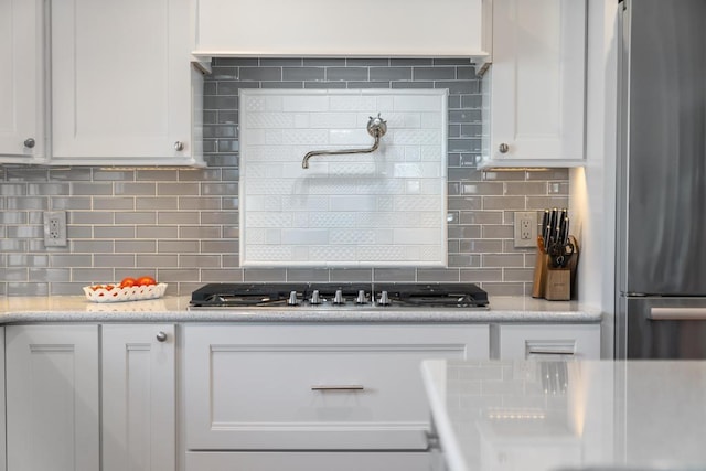 135 Beaubien Ave, Petoskey, MI 49770 - kitchen featuring appliances with stainless steel finishes, white cabinetry, tasteful backsplash, and light countertops