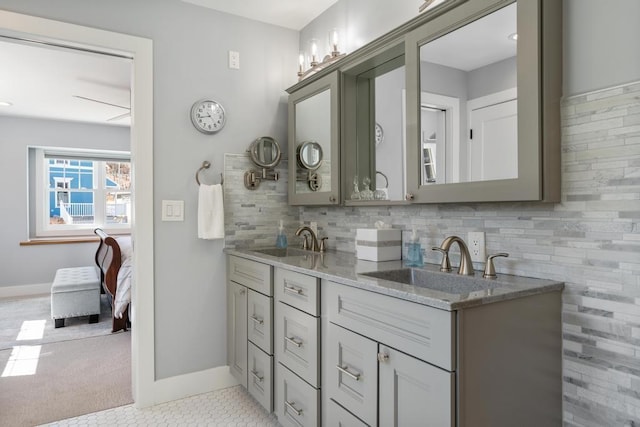 135 Beaubien Ave, Petoskey, MI 49770 - bathroom featuring double vanity, decorative backsplash, and tile patterned flooring