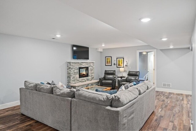 135 Beaubien Ave, Petoskey, MI 49770 - living room with wood finished floors, a stone fireplace, and recessed lighting