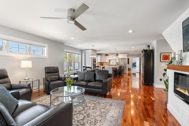 135 Beaubien Ave, Petoskey, MI 49770 - living area with a glass covered fireplace, dark wood-type flooring, a ceiling fan, and recessed lighting