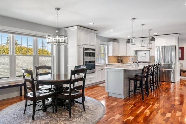 135 Beaubien Ave, Petoskey, MI 49770 - dining area featuring a chandelier, wood finished floors, and recessed lighting