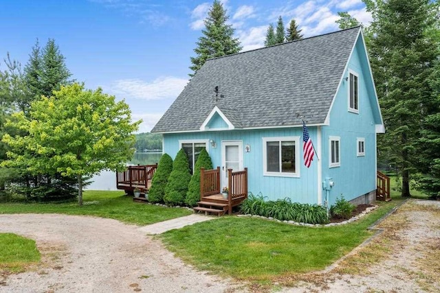 15700 Island Dr, Wolverine, MI 49799 - view of front of home with roof with shingles, a front yard, and a wooden deck