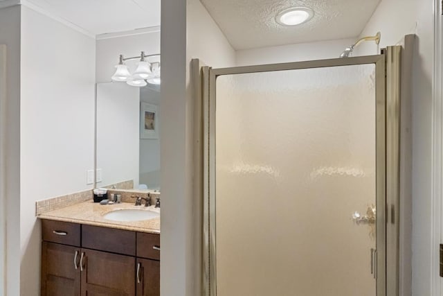 101 Michigan Ave Unit 107, Charlevoix, MI 49720 - full bath featuring a stall shower, vanity, and a textured ceiling