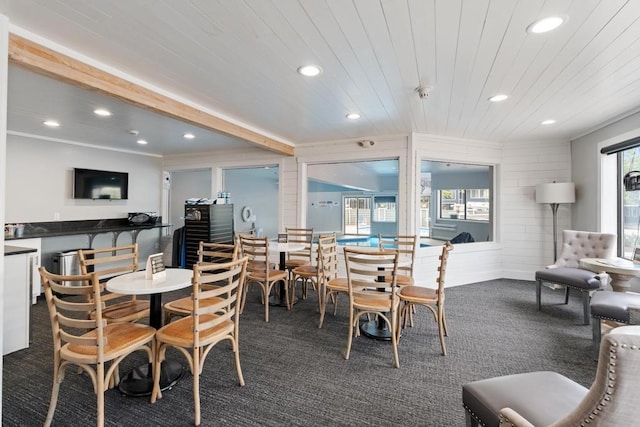 101 Michigan Ave Unit 107, Charlevoix, MI 49720 - dining room featuring recessed lighting, dark colored carpet, wooden ceiling, wooden walls, and ornamental molding
