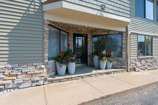 101 Michigan Ave Unit 107, Charlevoix, MI 49720 - property entrance featuring stone siding