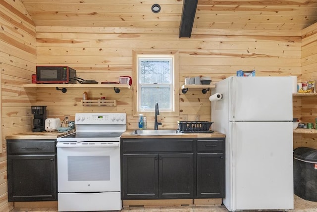 168 Townline Rd, Pellston, MI 49769 - kitchen with white appliances, wooden walls, wood ceiling, open shelves, and light countertops
