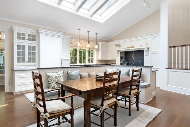 145 Traverse St, Harbor Springs, MI 49740 - dining room featuring dark wood-style flooring, a skylight, breakfast area, and high vaulted ceiling