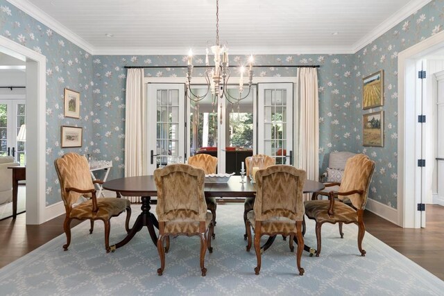 145 Traverse St, Harbor Springs, MI 49740 - dining room with wood finished floors, a chandelier, ornamental molding, and wallpapered walls