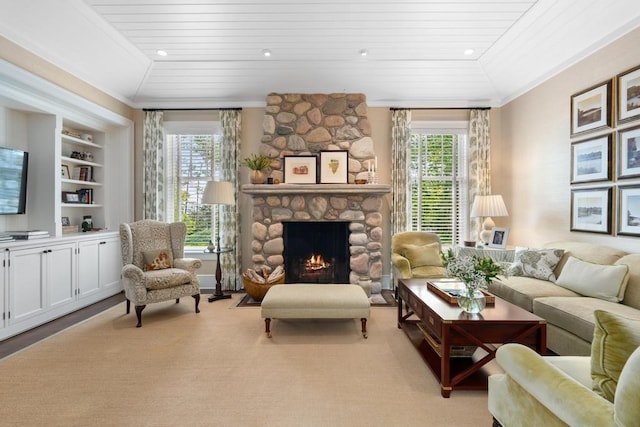 145 Traverse St, Harbor Springs, MI 49740 - living room with ornamental molding, healthy amount of natural light, a stone fireplace, wooden ceiling, and built in features
