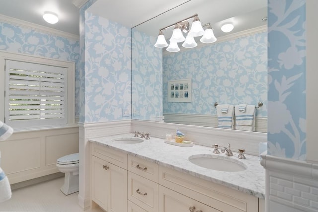 145 Traverse St, Harbor Springs, MI 49740 - full bath with wallpapered walls, double vanity, wainscoting, and crown molding