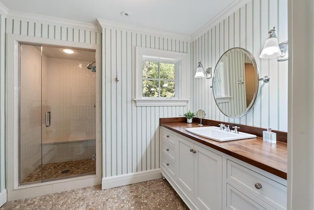 145 Traverse St, Harbor Springs, MI 49740 - full bathroom featuring vanity, ornamental molding, a stall shower, and wallpapered walls